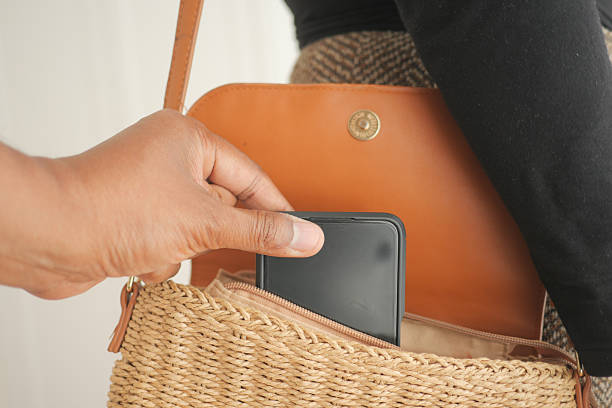 istock stealing smart phone from a woman purse 2238807369
