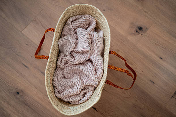 istock Pink knitted blanket in a basket bag. Cozy home decor. 2238812093