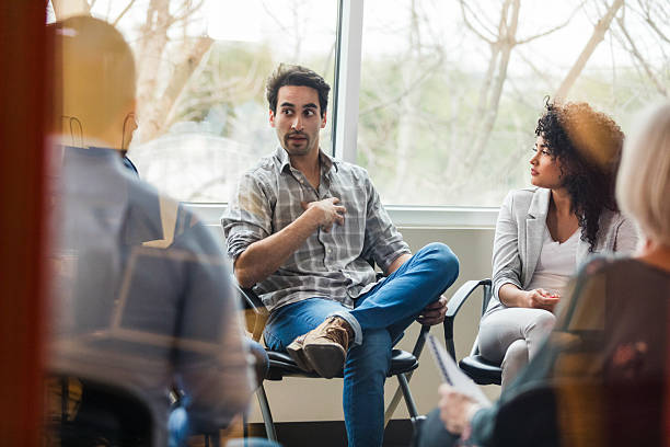 istock People participating in a group therapy session discussing personal matters, offering emotional support. 2238815742