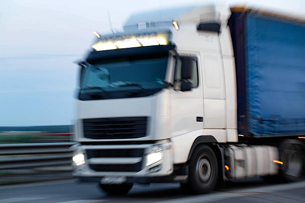 istock Fast moving truck on highway during early evening hours, blurry 2238823955