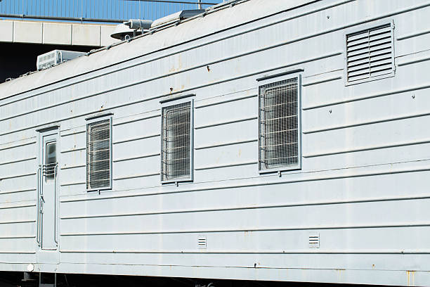 istock Windows behind bars in a special carriage for transporting prisoners, industry. Copy space for text 2238825834