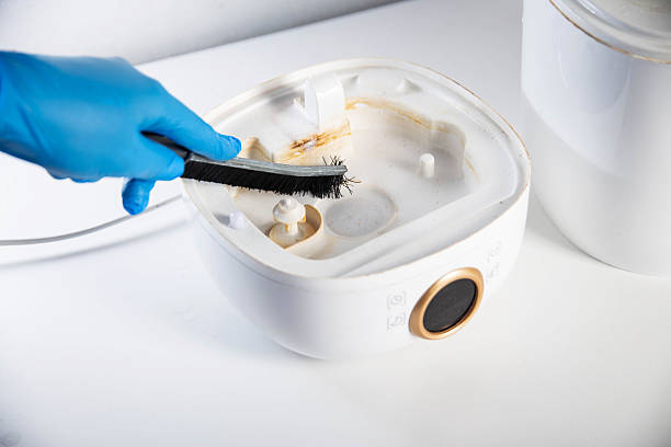 istock Cleaning the humidifier from scale, rust and unpleasant odors with a special brush and chemical agent. Service, close-up 2238826062