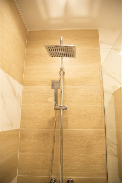 istock Modern chrome shower on brown porcelain tiles background. Modern bathroom interior. Copy space for text, cleanliness 2238826236