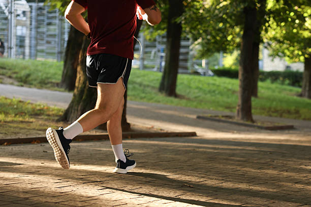 istock Athletic young man in sportswear running outdoors, closeup. Space for text 2238828242