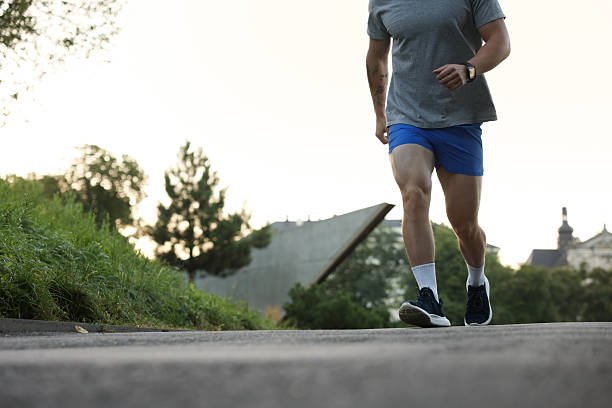 istock Athletic young man in sportswear running outdoors, closeup. Space for text 2238828323