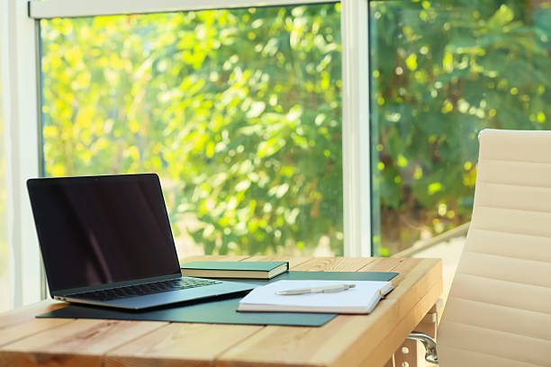 istock Home workplace. Laptop and stationery on wooden table 2238829221