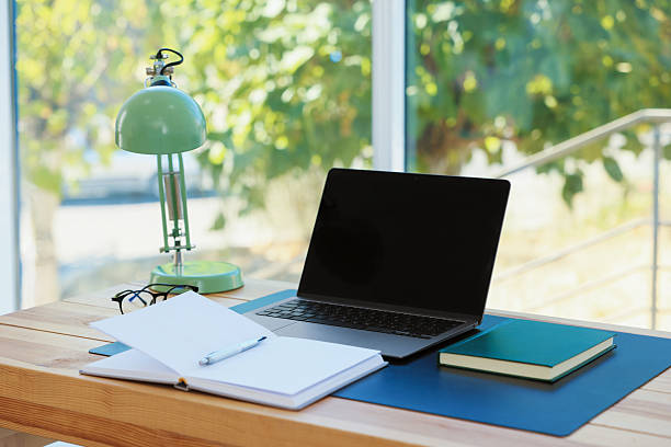 istock Home workplace. Laptop and stationery on wooden table 2238829257