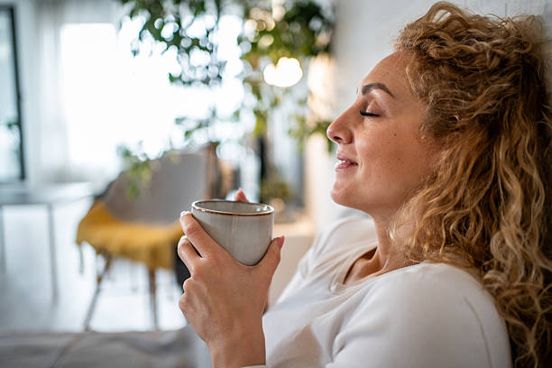 istock Woman relaxing with coffee feeling peaceful at home 2238829333