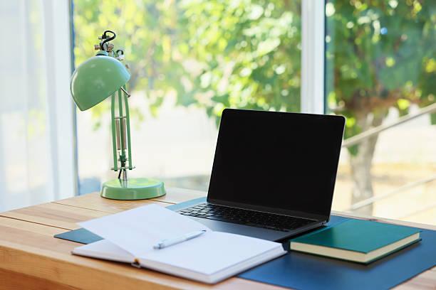 istock Home workplace. Laptop and stationery on wooden table 2238829441