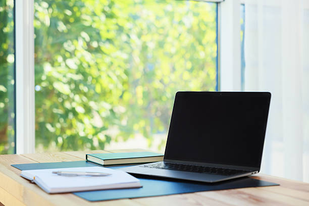 istock Home workplace. Laptop and stationery on wooden table 2238829454