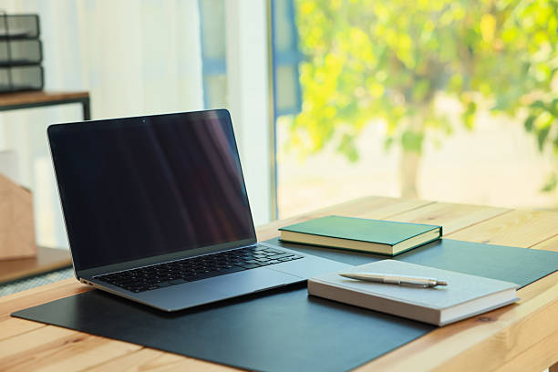 istock Home workplace. Laptop and stationery on wooden table 2238829471