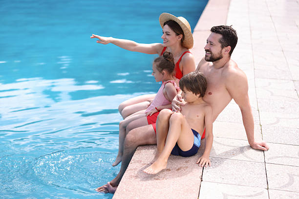 istock Happy family at poolside outdoors on sunny day, space for text 2238829756