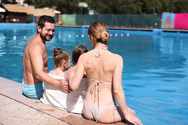 istock Family at poolside outdoors on sunny day 2238829761