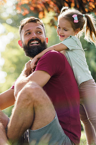 istock Smiling father and daughter hugging in park 2238831044
