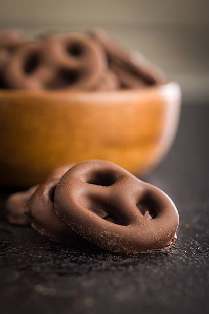 istock Chocolate covered pretzels on black table. 2238833402