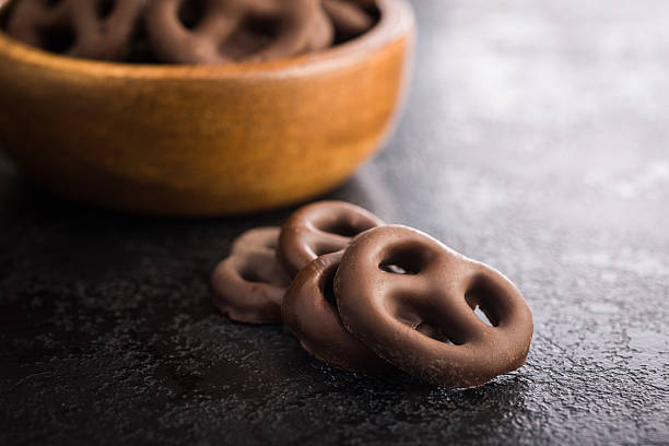 istock Chocolate covered pretzels on black table. 2238833403