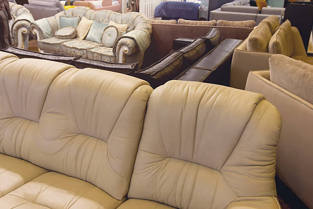 Furniture store with sofas and couches on display for sale. Showroom in the upholstered furniture store department with sofas