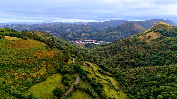istock Green hills with valley and distant mountain slopes 2238837405