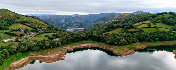 istock Lake surrounded by hills farmland and distant mountains 2238839117