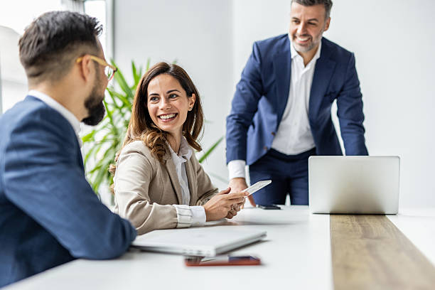 istock Business colleagues collaborating and laughing during office meeting 2238855595