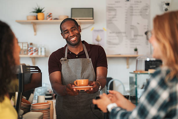 istock Waiter in cafe serving customer with coffee 2238857047