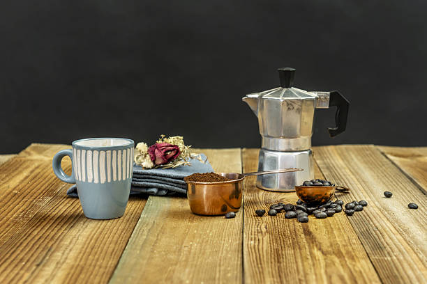 A still life with a vintage coffee maker with two services, ground coffee and roasted coffee beans