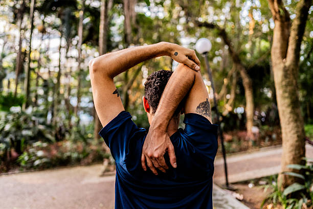 istock Mid adult man doing stretching exercise outdoors 2238870257