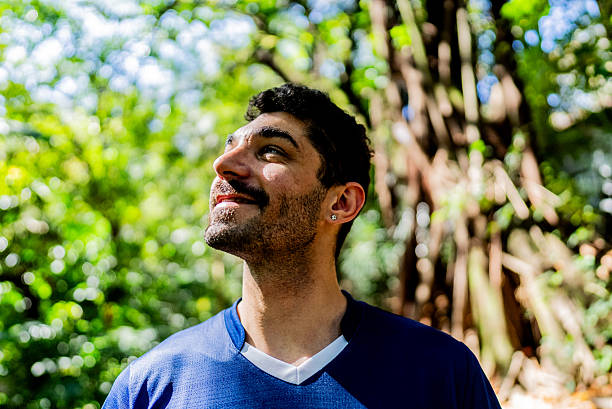 istock Smiling man contemplating nature outdoors in forest 2238870470