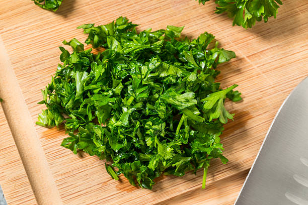 Raw Green Organic Minced Parsley on a Cutting Board