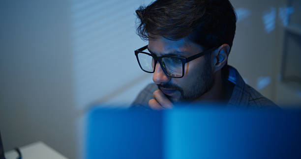 istock Hispanic Man Programmer with Glasses Working on Computer in The Office at Night. 2238882510