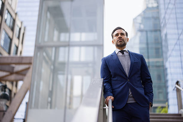 istock Confident Businessman Standing Amidst Urban Architecture 2238885895
