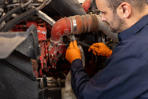 istock Male Mechanic in Blue Uniform Fixing Red Truck Engine with Tools 2238886053
