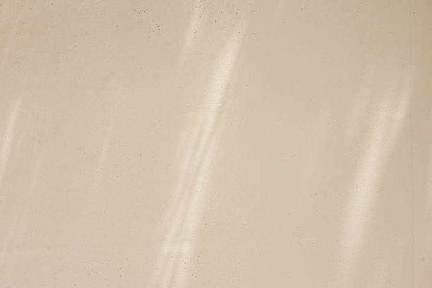 istock close up on beige plain wall background texture with shadow of window from sunlight for ads and advertisement product such as cosmetic or content or goods design display concept 2238886204