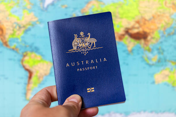 istock Australian passport held up in front of world map 2238888202