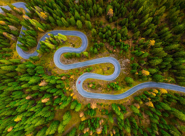 istock Windy mountain road and red car1 2238888324