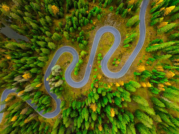 istock Windy mountain road and red car 2 2238888329