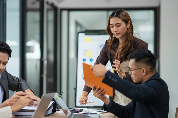istock A businesswoman is standing in a conference room presenting her work. 2238889550