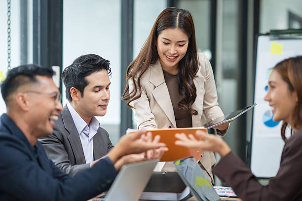 istock A businesswoman is standing in a conference room presenting her work. 2238889554