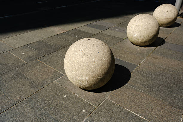 Large plain concrete balls to prevent vehicles accessing the public walkway.