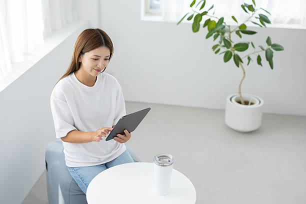istock Woman using tablet and smiling in bright room 2238891884