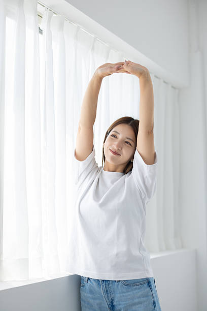 istock Woman stretching arms and smiling indoors 2238891955