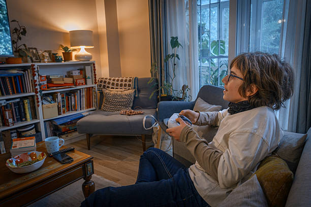 istock Person holding controller playing video game at home 2238892475