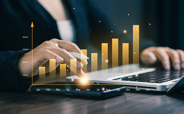 istock Hands using a laptop with glowing bar chart, representing business growth, financial analysis, market performance, and successful data-driven strategy in modern business. 2238893834