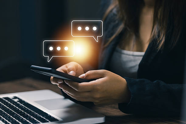 istock Close-up of woman using smartphone with chat bubble holograms, symbolizing instant messaging, online communication, social media interaction, and digital connectivity in modern lifestyle. 2238893878