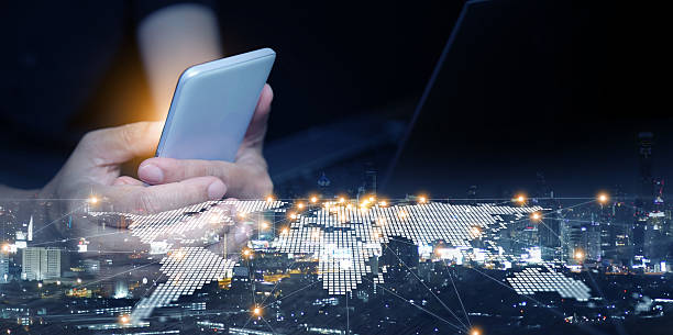 istock Close-up of businessman using smartphone with digital world map network overlay. Global business, internet technology, modern communication, worldwide connectivity, innovation. 2238895838