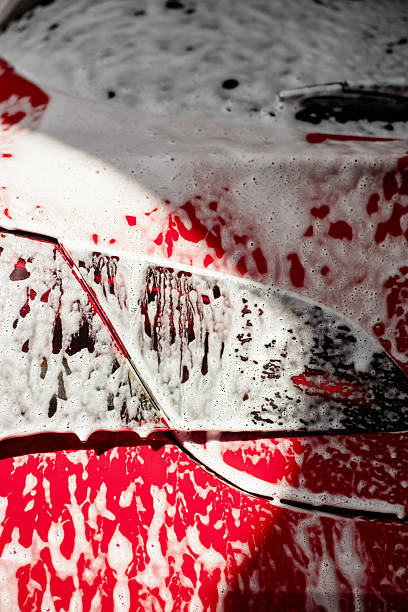 istock Red Car Hood Being Washed with Soap Suds during Vehicle Cleaning Process 2238895980