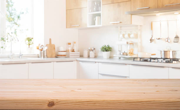 istock Food presentation background with empty wooden table top in front of blurred modern kitchen workspace interior 2238898278