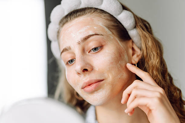 istock A close-up of a young woman's face with a mask reflected in a small mirror. 2238900246