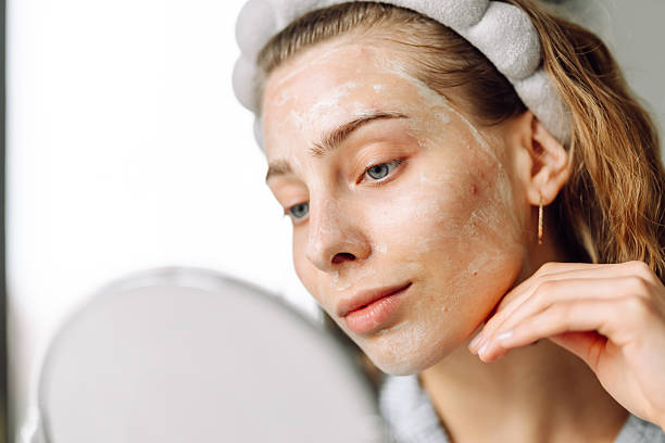 istock A close-up of a young woman's face with a mask reflected in a small mirror. 2238900248