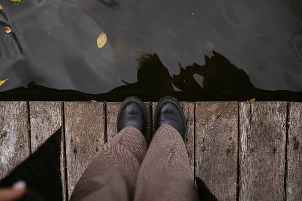 istock Looking Down Over Wooden Dock Water 2238900391
